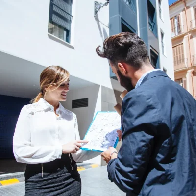 Porteiro de condomínio analisando informações com moradora.