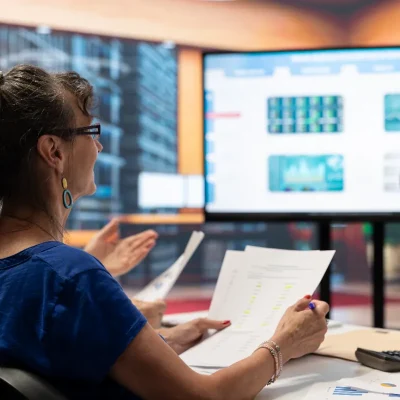 Sistemas para síndicos em reunião com dashboards de gestão