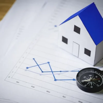 mercado condominial representado por miniatura de imóvel sobre gráficos financeiros